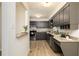 Charming kitchen features dark cabinets, stainless steel appliances, and granite countertops at 5819 Stonehaven Nw Dr, Kennesaw, GA 30152