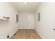 Clean laundry room with white walls, wood-look floors, and practical shelving at 5819 Stonehaven Nw Dr, Kennesaw, GA 30152