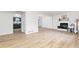 Spacious living room featuring sleek floors, a cozy fireplace, and bright, neutral paint at 5819 Stonehaven Nw Dr, Kennesaw, GA 30152