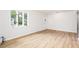 Open living room with new floors, lots of light, and a charming front door at 5819 Stonehaven Nw Dr, Kennesaw, GA 30152