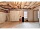 Unfinished basement with exposed ceiling and double doors at 8100 Greens Mill Way, Loganville, GA 30052