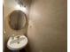 Cozy powder room showcases a pedestal sink, ornate mirror, and decorative wallpaper at 8100 Greens Mill Way, Loganville, GA 30052