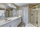 Spacious bathroom featuring double sinks, a glass-door shower, and a soaking tub at 8100 Greens Mill Way, Loganville, GA 30052
