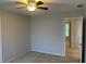 Neutral bedroom with a ceiling fan and view of adjoining room through an open door at 8100 Greens Mill Way, Loganville, GA 30052