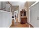 Welcoming entryway featuring hardwood floors, a staircase, and a stylish accent table at 8100 Greens Mill Way, Loganville, GA 30052