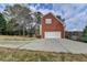 Brick home exterior with an attached garage and long driveway offers convenience and curb appeal at 8100 Greens Mill Way, Loganville, GA 30052