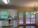 Sunlit kitchen with stainless steel sink, granite counters, and view of outdoor deck at 8100 Greens Mill Way, Loganville, GA 30052