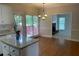 Open kitchen with granite counters, wood floors, and a view of the cozy living room at 8100 Greens Mill Way, Loganville, GA 30052