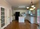 Spacious kitchen with white cabinets, granite countertops, stainless appliances, and hardwood floors at 8100 Greens Mill Way, Loganville, GA 30052
