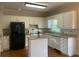 White kitchen features granite countertops, stainless steel appliances, and a central island at 8100 Greens Mill Way, Loganville, GA 30052