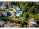 Aerial view of a community pool, playground, and surrounding homes, illustrating the Gathering-friendly amenities at 104 Marlow Dr, Woodstock, GA 30188