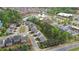 Aerial view of a residential community with mature trees, a pond, and a commercial area, blending nature and convenience at 104 Marlow Dr, Woodstock, GA 30188