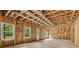Unfinished basement featuring insulation, windows, and a door to the backyard at 104 Marlow Dr, Woodstock, GA 30188