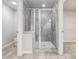 Bathroom featuring tiled walk-in shower with glass enclosure, and nearby walk-in closet at 104 Marlow Dr, Woodstock, GA 30188