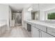 Bathroom featuring double sink vanity, large mirrors, walk-in shower, and soaking tub at 104 Marlow Dr, Woodstock, GA 30188