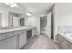 Bathroom featuring double sink vanity, large mirrors, walk-in shower, and soaking tub at 104 Marlow Dr, Woodstock, GA 30188
