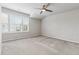 Bright bedroom features a ceiling fan, plush carpet, and a large window for natural light at 104 Marlow Dr, Woodstock, GA 30188
