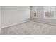 Bedroom boasts plush carpet and two windows, creating a bright, inviting space at 104 Marlow Dr, Woodstock, GA 30188