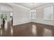Bright dining room features hardwood floors, fresh paint, modern chandelier and decorative wall trim at 104 Marlow Dr, Woodstock, GA 30188