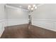 Bright dining room features hardwood floors, fresh paint, modern chandelier and decorative wall trim at 104 Marlow Dr, Woodstock, GA 30188