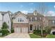 Charming two-story home features a brick and siding exterior, a two-car garage and manicured landscaping at 104 Marlow Dr, Woodstock, GA 30188