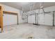 Spacious two-car garage featuring high ceilings, ample storage, and concrete flooring for easy maintenance and durability at 104 Marlow Dr, Woodstock, GA 30188