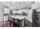 Kitchen with a large island, white cabinets, stainless steel appliances, and gray backsplash at 104 Marlow Dr, Woodstock, GA 30188