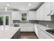 Open kitchen with stainless steel appliances, white cabinets, and granite counters at 104 Marlow Dr, Woodstock, GA 30188