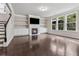 Spacious living room features hardwood floors, a fireplace and built-in shelving at 104 Marlow Dr, Woodstock, GA 30188