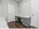 Mudroom with built-in desk with granite countertops, drawers, and dark hardwood flooring at 104 Marlow Dr, Woodstock, GA 30188