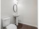 This powder room features modern fixtures, fresh paint and hardwood floors at 104 Marlow Dr, Woodstock, GA 30188