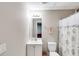 Neat bathroom featuring a vanity, toilet and shower with curtain; a practical space for everyday use at 1058 Magnolia Dr, Villa Rica, GA 30180