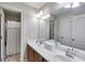 Bright bathroom featuring a double sink vanity with modern fixtures and a shower with curtain at 1058 Magnolia Dr, Villa Rica, GA 30180