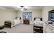 Cozy bedroom with two beds, dark wood furniture, neutral carpet, and a floral window covering at 1058 Magnolia Dr, Villa Rica, GA 30180