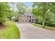 Exterior view of a home with a long driveway surrounded by trees, offering privacy and curb appeal at 1058 Magnolia Dr, Villa Rica, GA 30180