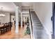 Bright foyer featuring hardwood floors, a staircase with iron railings, and an open view to living spaces at 1058 Magnolia Dr, Villa Rica, GA 30180