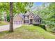Charming home with a stone and siding exterior, two-car garage, and beautifully landscaped front yard at 1058 Magnolia Dr, Villa Rica, GA 30180