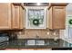 Kitchen featuring dark countertops, wood cabinets, and a stainless steel sink at 1058 Magnolia Dr, Villa Rica, GA 30180