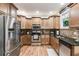 Well-equipped kitchen featuring stainless steel appliances, granite countertops, and hardwood floors at 1058 Magnolia Dr, Villa Rica, GA 30180