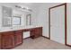 Bathroom with double sinks and vanity under a large mirror and a shower visible in the background at 5589 Dendy Trc, Fairburn, GA 30213