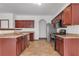 Updated kitchen featuring stainless steel appliances, granite countertops, and tile flooring at 5589 Dendy Trc, Fairburn, GA 30213
