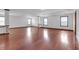 Large living room with hardwood floors, white walls, and lots of natural light at 5589 Dendy Trc, Fairburn, GA 30213