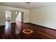 Spacious living room showcasing hardwood floors and a distinctive starburst inlay design at 5589 Dendy Trc, Fairburn, GA 30213