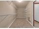 Walk-in closet with carpeted floors and shelving at 5589 Dendy Trc, Fairburn, GA 30213