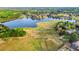 A scenic aerial view of a golf course community with a lake surrounded by lush greenery and well-maintained homes at 750 Southland Pass, Stone Mountain, GA 30087
