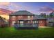 The backyard features a spacious deck and well-kept lawn surrounded by mature trees and a glimpse of the neighboring homes at 750 Southland Pass, Stone Mountain, GA 30087