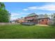 Large backyard featuring a spacious deck and lush green lawn, perfect for outdoor activities at 750 Southland Pass, Stone Mountain, GA 30087