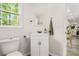 Clean and bright bathroom with white vanity, toilet, and natural light at 750 Southland Pass, Stone Mountain, GA 30087