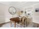 Cozy dining area with a round table, decorative accents, and view into kitchen at 750 Southland Pass, Stone Mountain, GA 30087