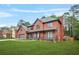 Charming two-story brick home with a well-manicured lawn, covered porch, and attached garage in a suburban neighborhood at 750 Southland Pass, Stone Mountain, GA 30087